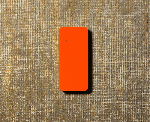 Оранжевый считыватель карт Mifare - AXI1 в интерьере на бежевом фоне